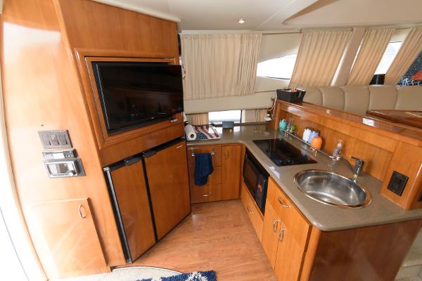 Slide: The Image of Interior of a 2006 Carver 38 Super Sport yacht kitchen with modern amenities. - 16