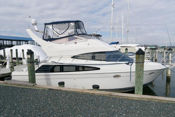 Slide: The Image of 2006 Carver 38 Super Sport yacht docked at a marina. - 2