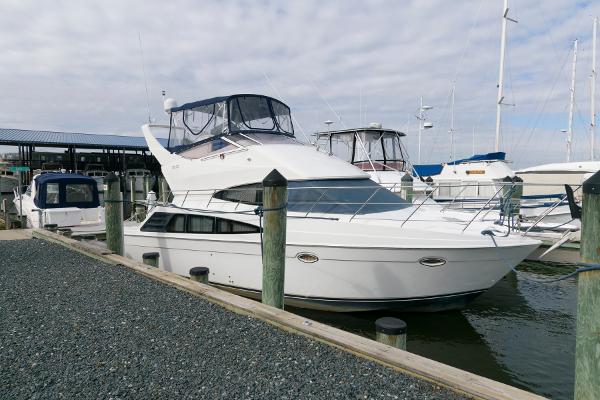 Slide: The Image of 2006 Carver 38 Super Sport yacht docked at a marina. - 4