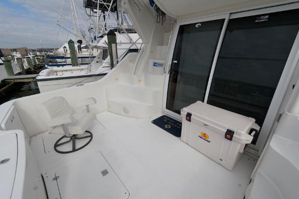 Slide: The Image of 2006 Carver 38 Super Sport boat deck with seating and storage. - 5