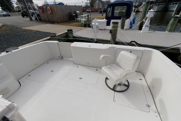Slide: The Image of 2006 Carver 38 Super Sport boat deck with white seating at a marina. - 6