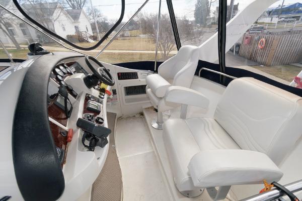 Slide: The Image of 2006 Carver 38 Super Sport helm with white leather seats and control panel. - 8