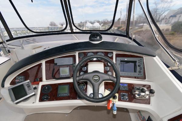 Slide: The Image of 2006 Carver 38 Super Sport helm with navigation instruments and steering wheel. - 9