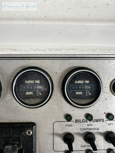 Slide: The Image of Control panel of 1988 Carver 4207 Aft Cabin with elapsed time gauges and bilge pump switches. - 32