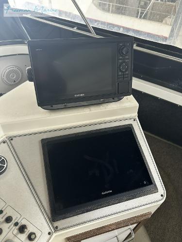 Slide: The Image of 1988 Carver 4207 Aft Cabin helm with Garmin navigation displays. - 33