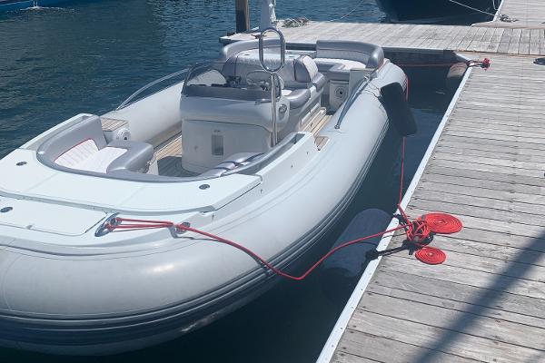 Slide: The Image of 2015 Castoldi 21 Diesel Jet Tender docked at a marina. - 2