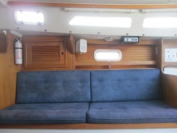 Slide: The Image of Interior of 1999 Catalina 30 MkIII sailboat with blue cushioned seating. - 4