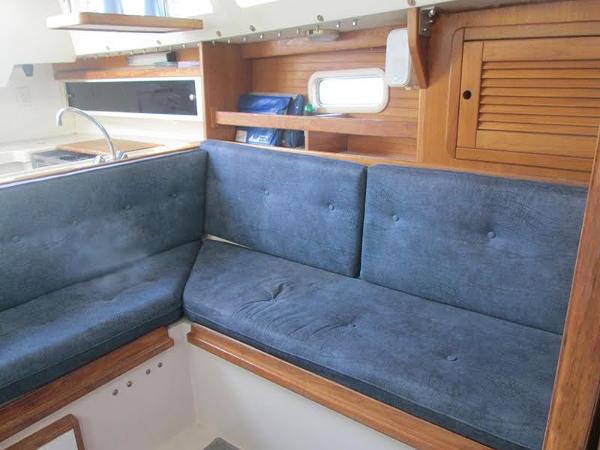 Slide: The Image of Interior seating area of a 1999 Catalina 30 MkIII sailboat with blue cushions. - 7