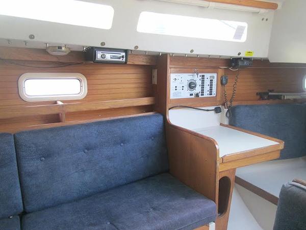Slide: The Image of Interior of a 1999 Catalina 30 MkIII sailboat with blue seating and navigation station. - 9