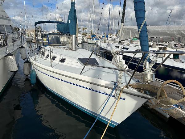 Slide: The Image of Catalina 34 MkII 2000 sailboat docked in a marina, surrounded by other boats. - 0