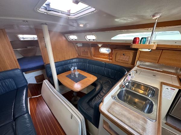 Slide: The Image of Interior of 2000 Catalina 34 MkII sailboat with cozy seating and compact kitchen area. - 10