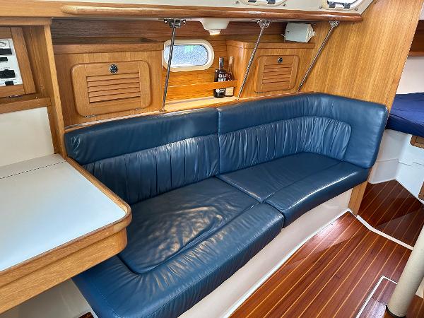 Slide: The Image of Interior of 2000 Catalina 34 MkII sailboat with blue leather seating and wooden accents. - 12