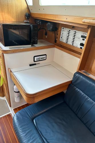Slide: The Image of Interior of 2000 Catalina 34 MkII yacht with navigation station and microwave. - 14