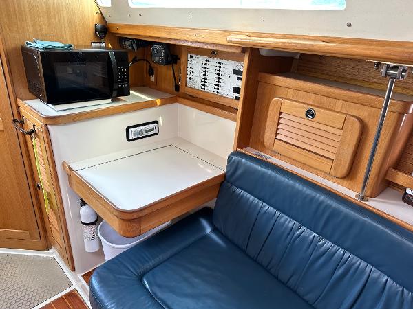Slide: The Image of Interior of 2000 Catalina 34 MkII sailboat with seating, table, and microwave. - 15
