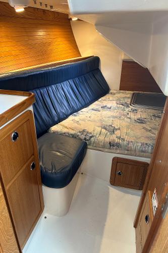 Slide: The Image of Interior cabin of a 2000 Catalina 34 MkII sailboat with wood and blue upholstery. - 17