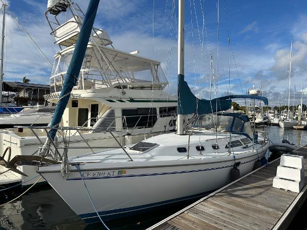 Slide: The Image of 2000 Catalina 34 MkII sailboat docked at marina under clear blue sky. - 2