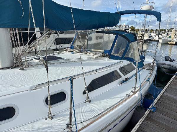Slide: The Image of 2000 Catalina 34 MkII sailboat docked at marina with blue canvas cover. - 3