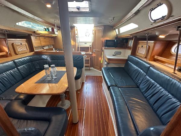 Slide: The Image of Interior of 2000 Catalina 34 MkII sailboat with wood finish and blue seating. - 8