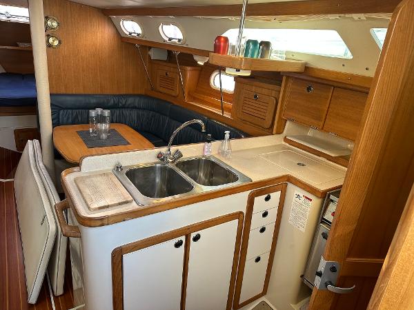 Slide: The Image of Interior of 2000 Catalina 34 MkII sailboat with kitchen and dining area. - 9