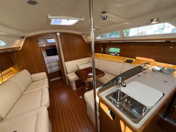Slide: The Image of 2024 Catalina 355 yacht interior with modern kitchen and cozy seating area. - 10