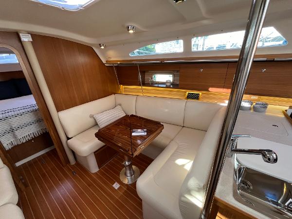 Slide: The Image of 2024 Catalina 355 yacht interior with modern wood finish and cozy seating area. - 12