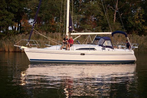 Slide: The Image of 2024 Catalina 355 sailboat on calm water with people onboard. - 13
