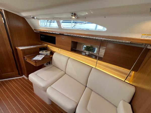 Slide: The Image of Interior of 2024 Catalina 355 sailboat with modern wood finish and white leather seating. - 13