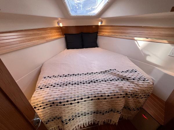 Slide: The Image of 2024 Catalina 355 yacht interior cabin with cozy bed and natural light. - 16