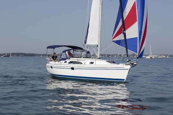 Slide: The Image of 2024 Catalina 355 sailboat with colorful spinnaker sailing on calm waters. - 17