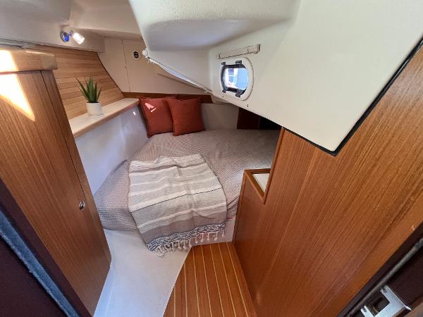 Slide: The Image of 2024 Catalina 355 yacht interior cabin with cozy bed and wooden finishes. - 20