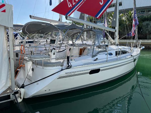 Slide: The Image of 2024 Catalina 355 sailboat docked in marina with red sails. - 23