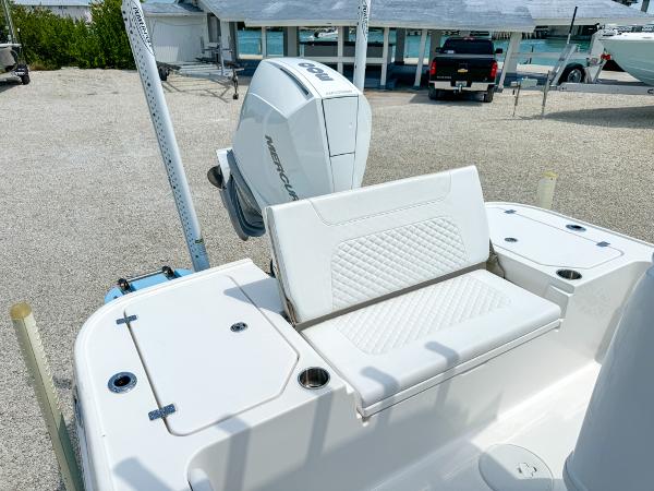 Slide: The Image of 2023 Caymas 26 HB boat with Mercury outboard engine and white seating. - 10