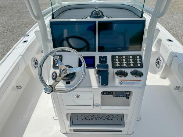Slide: The Image of 2023 Caymas 26 HB boat console with steering wheel, dual screens, and control panel. - 11