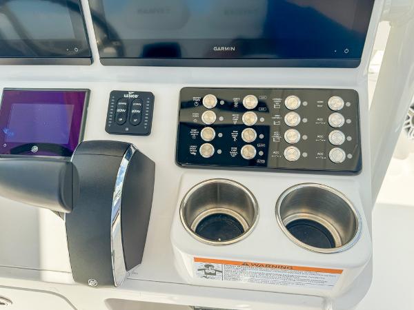 Slide: The Image of Control panel of 2023 Caymas 26 HB boat with Garmin display and cup holders. - 13
