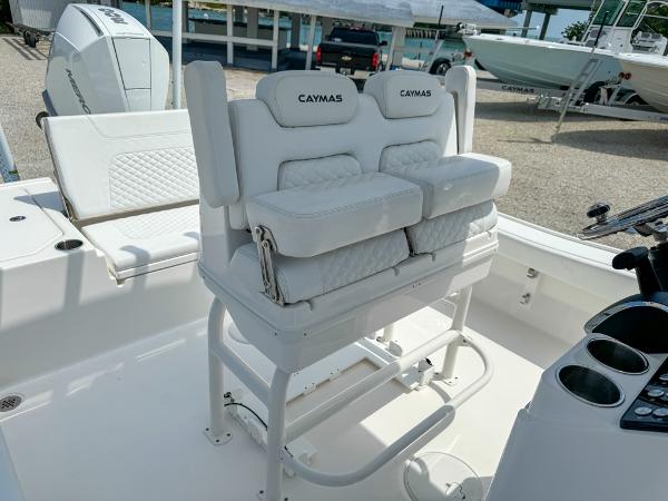 Slide: The Image of 2023 Caymas 26 HB boat interior with cushioned seating and console. - 14