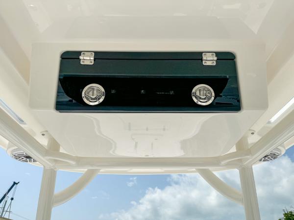 Slide: The Image of 2023 Caymas 26 HB boat console with storage compartment and latches. - 17