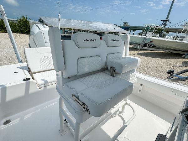 Slide: The Image of 2023 Caymas 26 HB boat with white cushioned seating and backrest. - 18