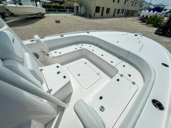 Slide: The Image of 2023 Caymas 26 HB boat interior with spacious seating and storage compartments. - 19