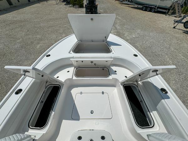 Slide: The Image of 2023 Caymas 26 HB boat with open storage compartments. - 21