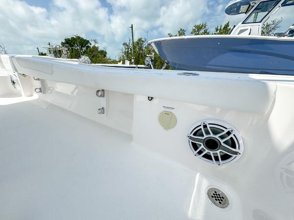 Slide: The Image of 2023 Caymas 26 HB boat interior with speaker and white seating. - 24