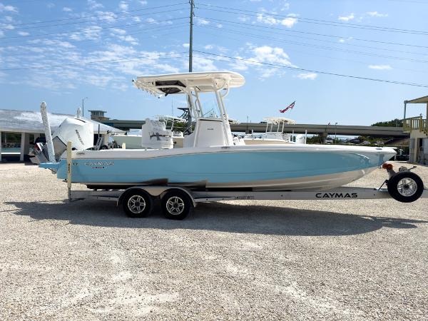 Slide: The Image of 2023 Caymas 26 HB boat on a trailer in a marina. - 6