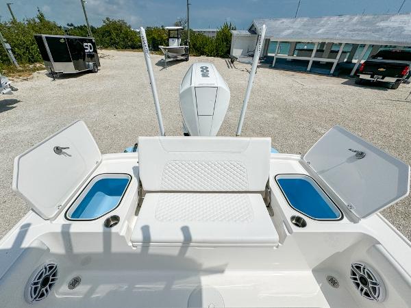 Slide: The Image of 2023 Caymas 26 HB boat with open storage compartments and seating. - 9