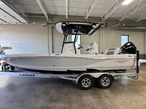Slide: The Image of 2024 Caymas 26 Hybrid boat on trailer in indoor showroom. - 0