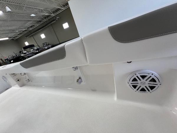Slide: The Image of 2024 Caymas 26 Hybrid boat interior with cushioned seating and speaker system. - 10