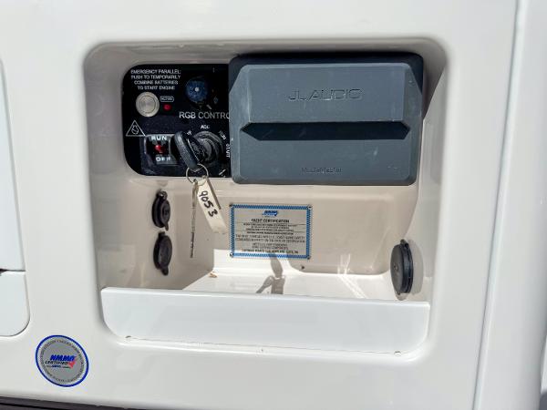 Slide: The Image of Control panel of 2024 Caymas 26 HB boat with key and switches. - 15