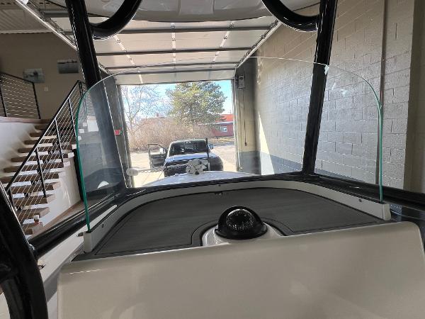 Slide: The Image of 2024 Caymas 26 Hybrid boat interior view with windshield and compass. - 20
