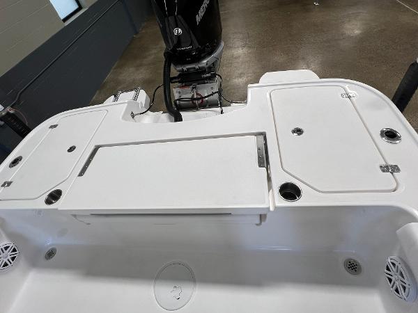 Slide: The Image of 2024 Caymas 26 Hybrid boat stern with storage compartments and Mercury outboard motor. - 23