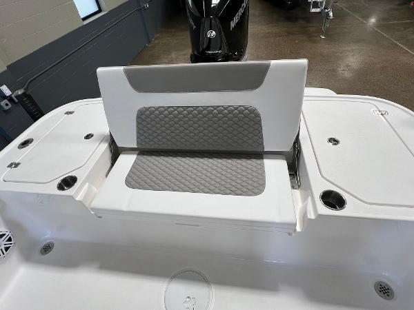 Slide: The Image of 2024 Caymas 26 Hybrid boat with cushioned seating and storage compartments. - 24