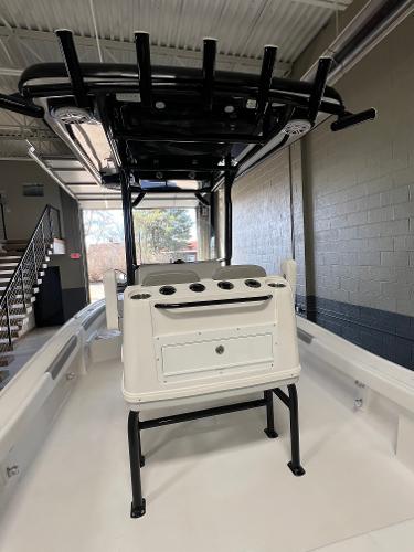 Slide: The Image of 2024 Caymas 26 Hybrid boat interior with rod holders and storage compartments. - 27
