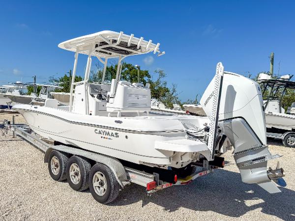 Slide: The Image of 2024 Caymas 26 HB boat on a trailer, featuring a sleek design and powerful outboard motor. - 3